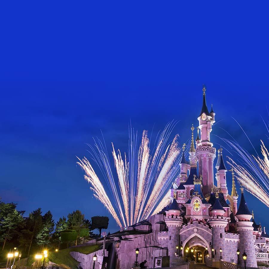Disney castle at night with fireworks