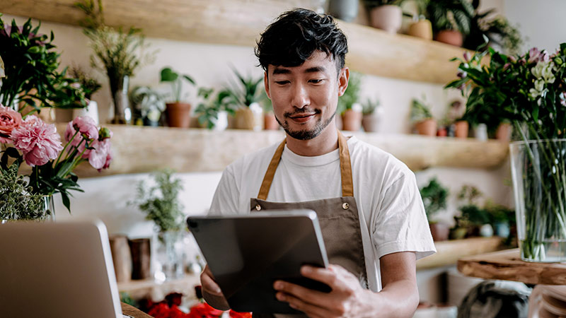 merchant typing on tablet